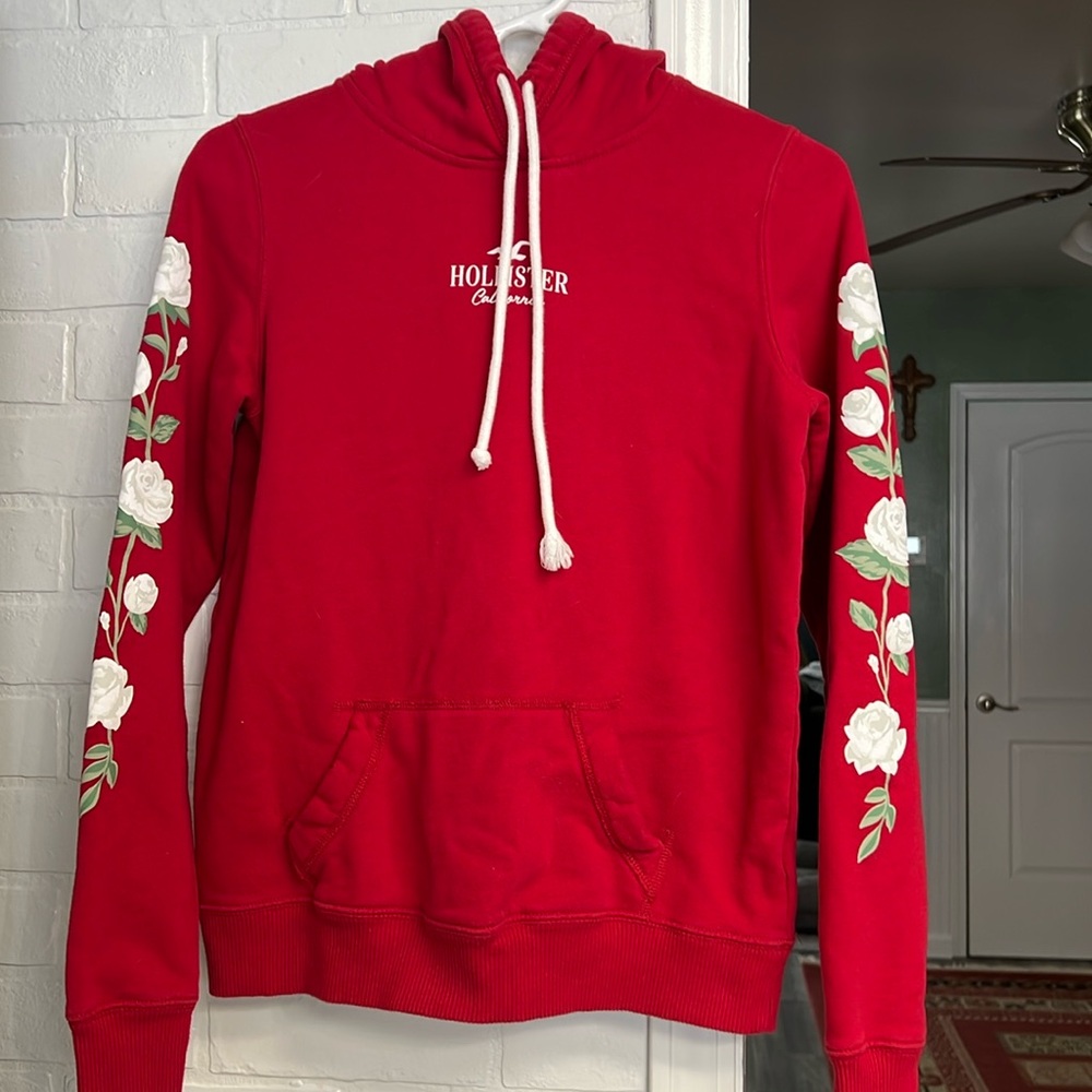 Hollister hooded red sweatshirt with flowers on arms.  Super cute! XS